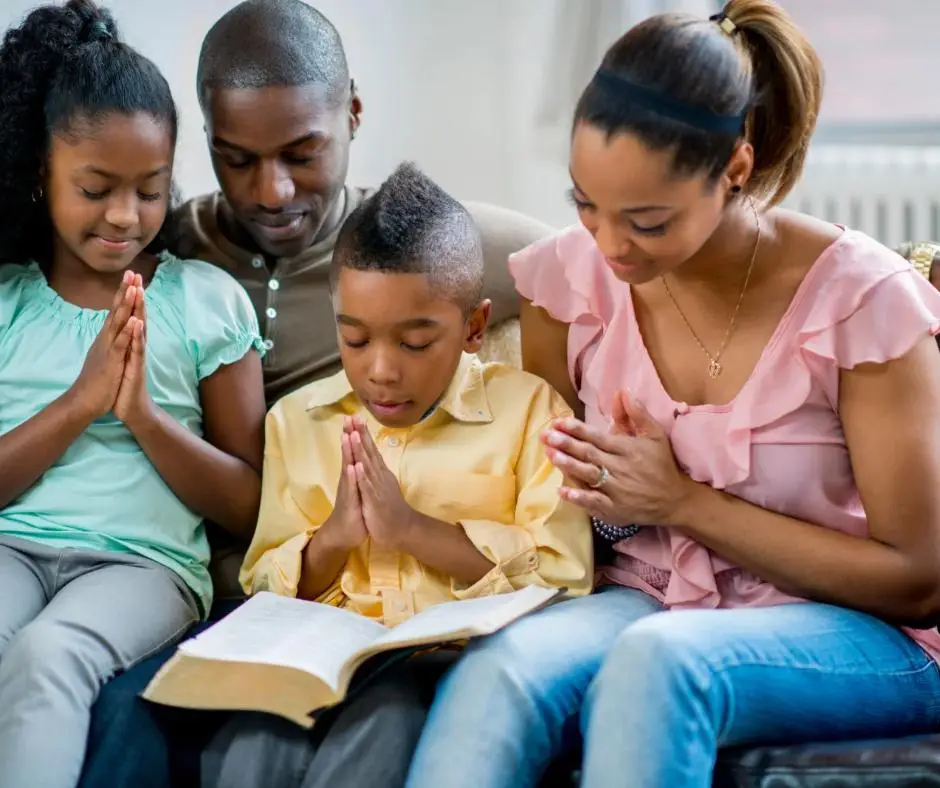 Christian family praying together at home